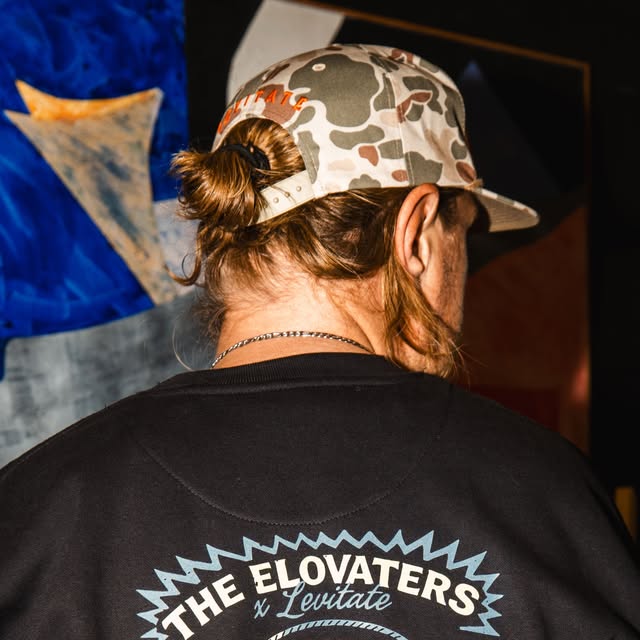 The Elovaters x Levitate crewneck and camo cap